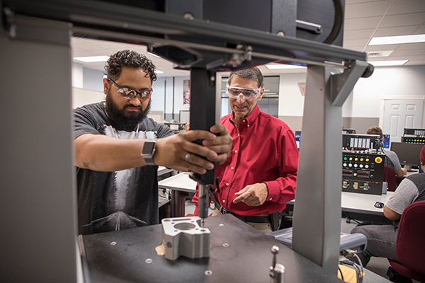 Professor working with students in lab